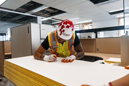 Safety-certified worker writing on a worksite